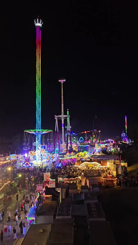 Panoramic Night View of a Fairground with Tower Rides and Carnival Lights Stock Footage 341628894