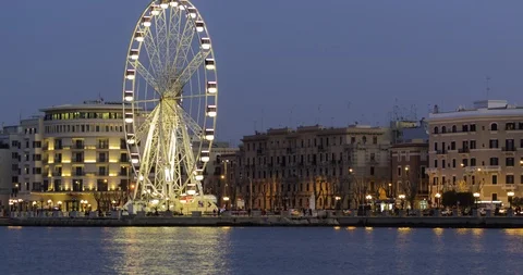 Panoramic Night view of Illuminated giant Ferris wheel on the waterfront of B Stock-Footage 104853553