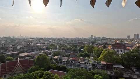 Panoramic nighttime view of green Bangkok at sunset from Buddhist temple window Video stock 339978557