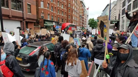 Panoramic Pan of Huge Crowd Marching BLACK LIVES MATTER Crowd in London Rally 4K Stock Footage 132078234