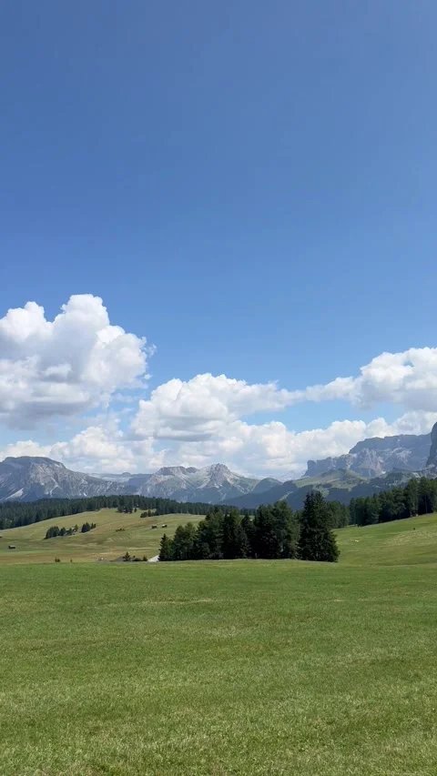 Panoramic panning view of green alpine meadow with majestic Dolomites mountain  Stock Footage 343682049