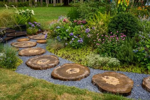 Panoramic picture of log steps and colorful flowers Stock Photos