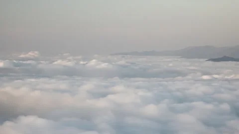 Panoramic Pyrenees mountain ridge above cloud sea, slanting sun rays in soft Stockbeeldmateriaal 333782917