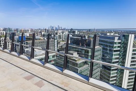 Panoramic rooftop view of modern city skyline with terrace railing. London, UK Stock Photos