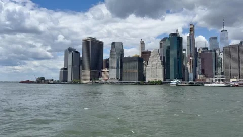 Panoramic, scenic view of Lower Manhattan. East River waves. New York City Stock Footage 337837823