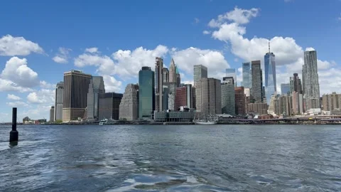 Panoramic, scenic view of Lower Manhattan. East River waves. New York City Stock Footage 337837898