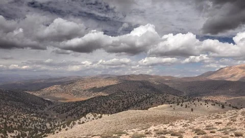 Panoramic semiarid mountain landscape with sparse trees under clouds Pakistan Stock Footage 339562400