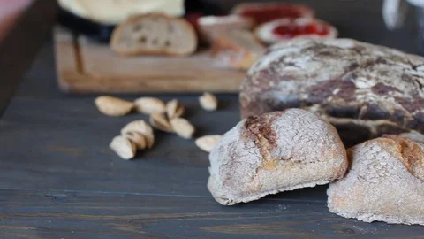 Panoramic shooting of black bread. Rolls lie on a wooden table of dark wood. The Stock Footage 79831297