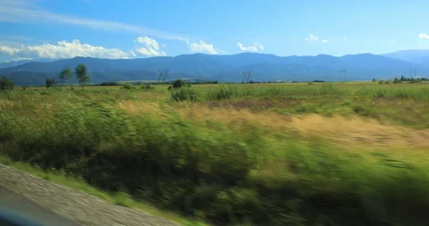 Panoramic shooting from the car in motion with mountains Video stock 138949397