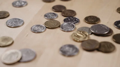 Panoramic shooting of coins lying on the table Video stock 152415719