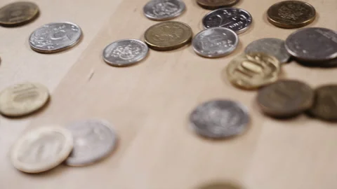 Panoramic shooting of coins lying on the table Video stock 152416552