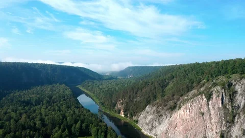 Panoramic shooting over the mountainous area, a river flows along the gorge. 스톡 동영상 114868816