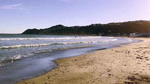 Panoramic  Shot of Beach with Sufers in the Distance Stock Footage 169497046