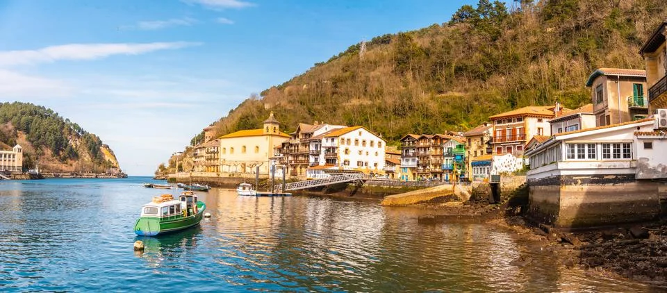 A panoramic shot of a beautiful coastal town Pasajes in Spain surrounded by g Stock Photos