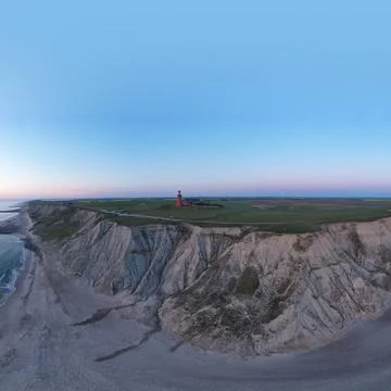 Panoramic shot of a lighthouse on a cliff Stock Photos