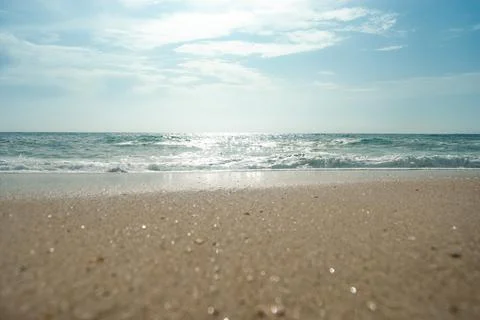 Panoramic shot of an ocean waves, beautiful sand sparkling at the sun Stock Photos