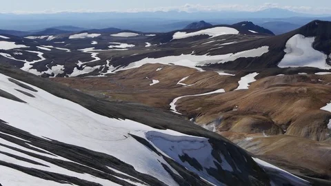 Panoramic shot over epic landscape in Iceland, with snowy peaks and a hiker Stock Footage 71281875