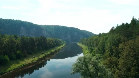 Panoramic shot over the river with a view of the mountain. 스톡 동영상 114871999