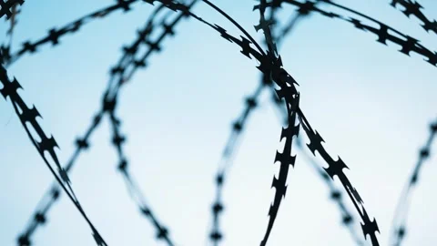Panoramic shot of the prison's barbed wire. Stock Footage 303568470