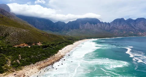 Panoramic shot of pristine beach and mountain range along Kogel Bay Stock Footage 333069064