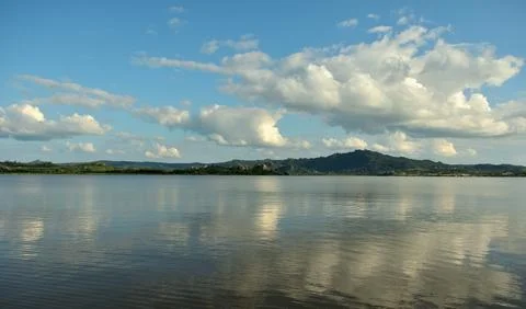 Panoramic shot of the ribbed surface of a large lake at the foot of a mount.. Stock Photos