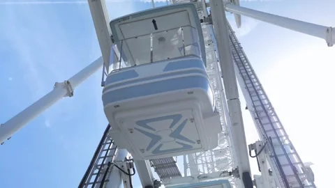 Panoramic shot seen from the bottom of a Ferris wheel cabin Stock Footage 247912346