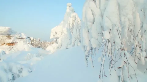 Panoramic shot of the snow forest, tall stones on a sunny day 스톡 동영상 59608477