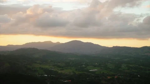 Panoramic shot of a sunset sky over the mountains with misty forest. Beautiful Stock Footage 208438209