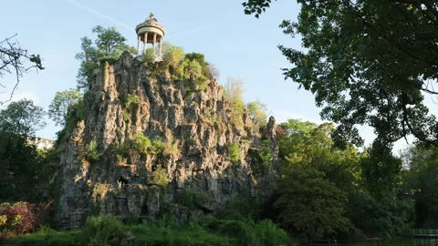 Panoramic Shot of Temple de la Sibylle on High Rocky Cliff Face at Parc des Butt Stock Footage 338383401