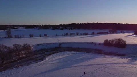 Panoramic shot of white snowy fields and a frozen river, 2K Video stock 196027991