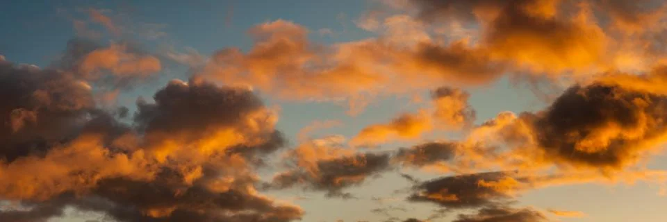 Panoramic sky view with clouds backlit by bright sunlight Stock Photos