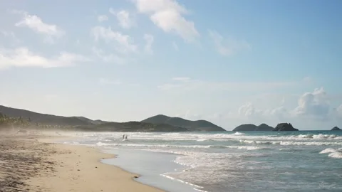 Panoramic slow motion shot of beautiful tropical beach at sunset. Mountains on Video stock 225088065