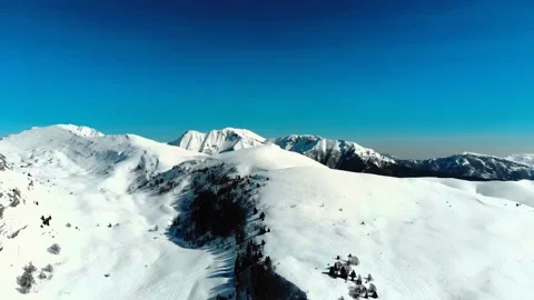 Panoramic snowy mountain peaks under clear blue sky Stock Footage 340962714