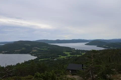 Panoramic summer view of forest and rugged coastline from the summit of Skule Stock Photos