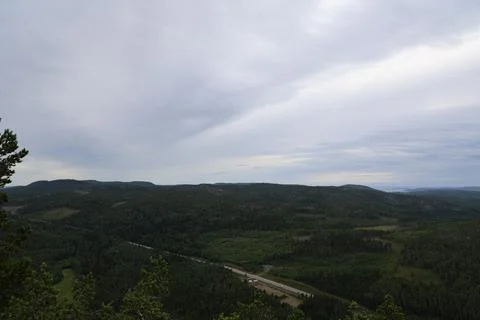 Panoramic summer view of forest and rugged coastline from the summit of Skule Stock Photos