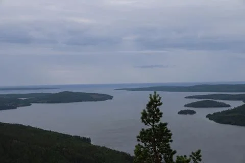 Panoramic summer view of forest and rugged coastline from the summit of Skule Stock Photos