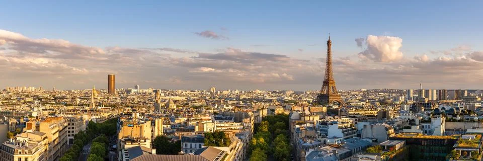 Panoramic summer view of Paris rooftops at sunset with the Eiffel Tower Stock Photos