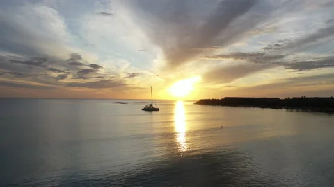 Panoramic sunrise at beach with sailing boat Stock Footage