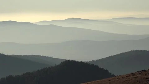 Panoramic sunrise view of consecutive mountain layers and hills forming calm Vídeos de archivo 333719801
