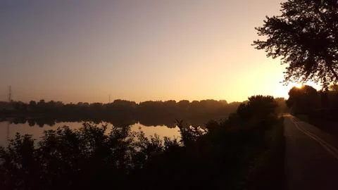 Panoramic Sunset over Lake with Tree Silhouettes Foto stock