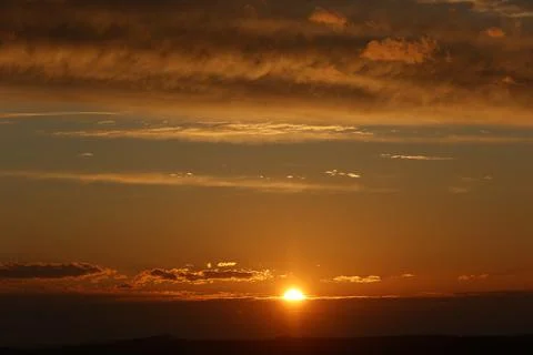 Panoramic sunset with sun and clouds 写真素材