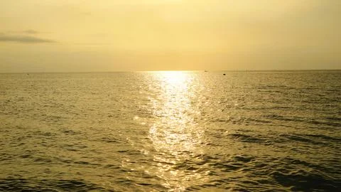 Panoramic sunset view at a beach in the tropics over calm ocean Stock Photos