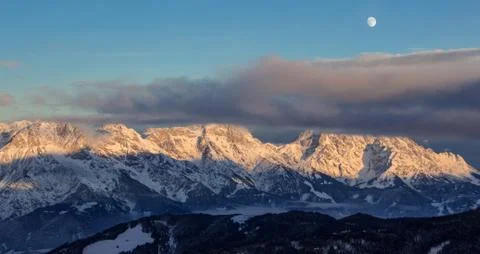 Panoramic sunset view moon Saalbach skiing Mountain moonrise dark mood 写真素材