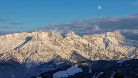 Panoramic sunset view moon Saalbach skiing Mountain moonrise dark mood Stock Photos