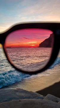 Panoramic sunset view watching  through sunglasses from Marina Grande beach.. Stock Photos