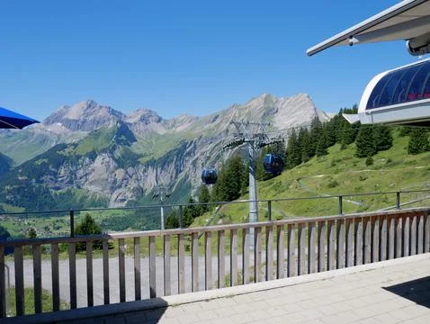 Panoramic terrace view of alpine mountain ranges near a cable car station Stock Photos