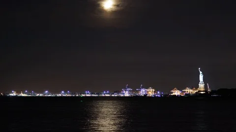Panoramic time-lapse of the Half Moon setting over the Statue of Liberty Stock Footage 95400033