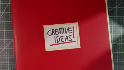 Panoramic top down view of Creative Ideas red notebook Stock Footage 341269384