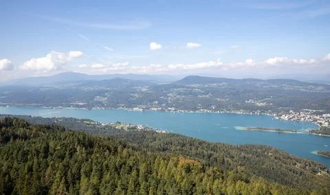 Panoramic top view of the green Austrian Alps, villages and Werthersee lake Stock Photos