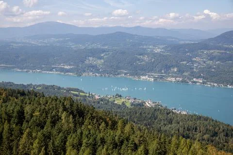 Panoramic top view of the green Austrian Alps, villages and Werthersee lake Stock Photos